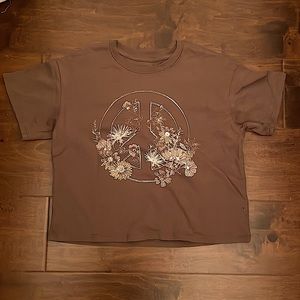 This peace sign T-shirt is Kat and Jack brand. It’s mostly brown Some white.